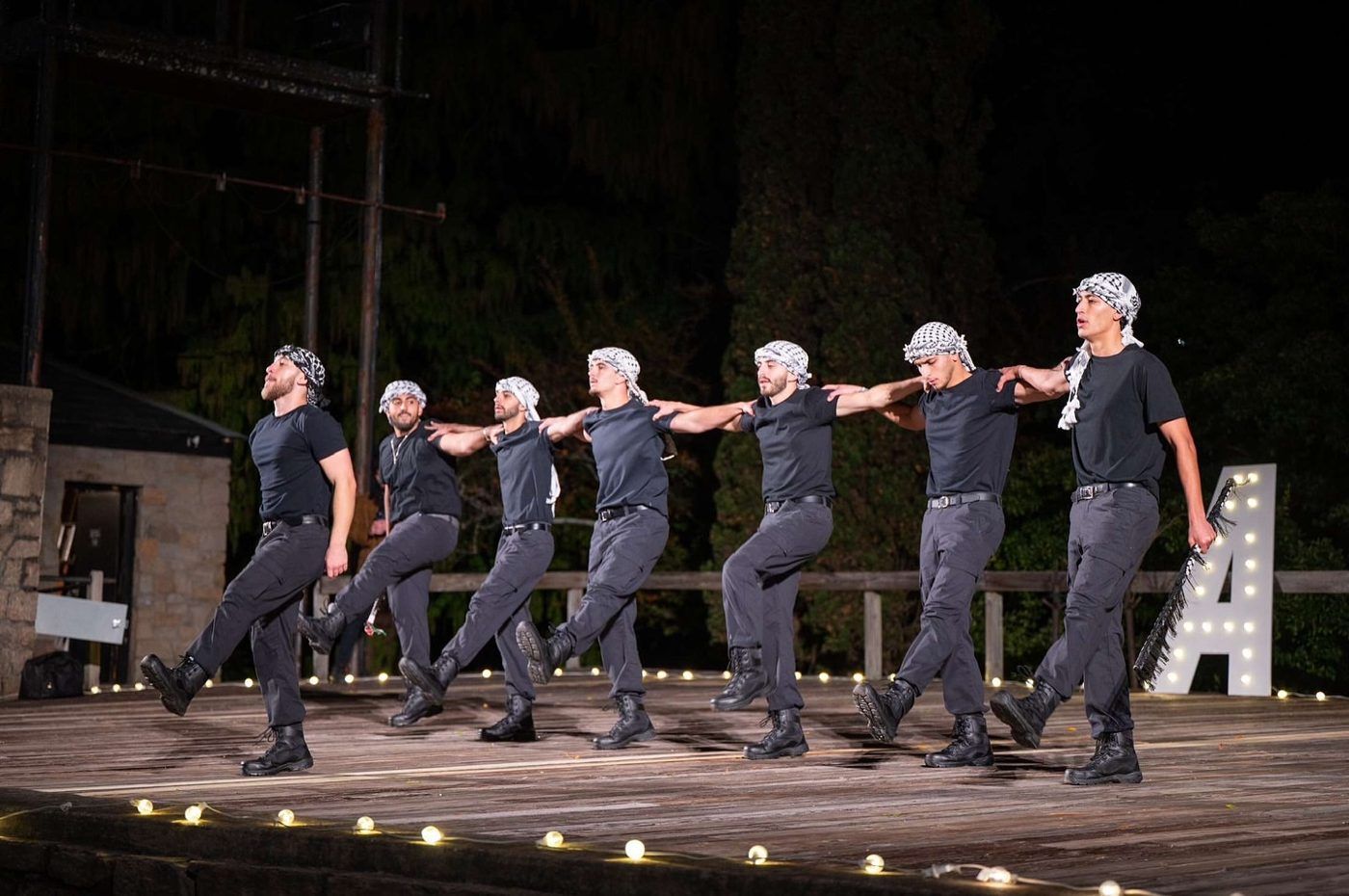 Hayat Al-Dabka performing a dabka line on an outdoor stage at a show, North Carolina