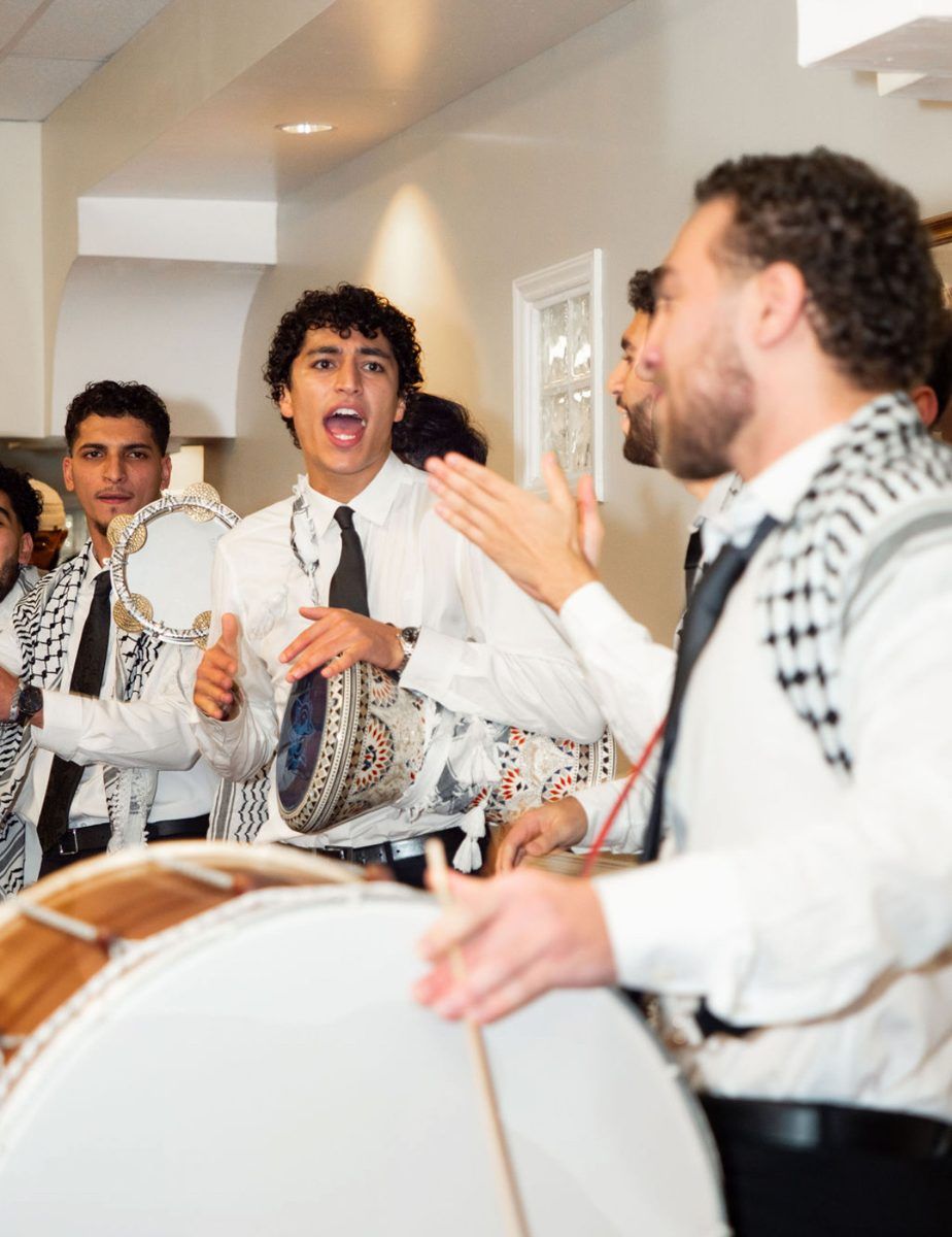 Hayat Al-Dabka drummer in a keffiyeh at a wedding zaffa, Raleigh NC